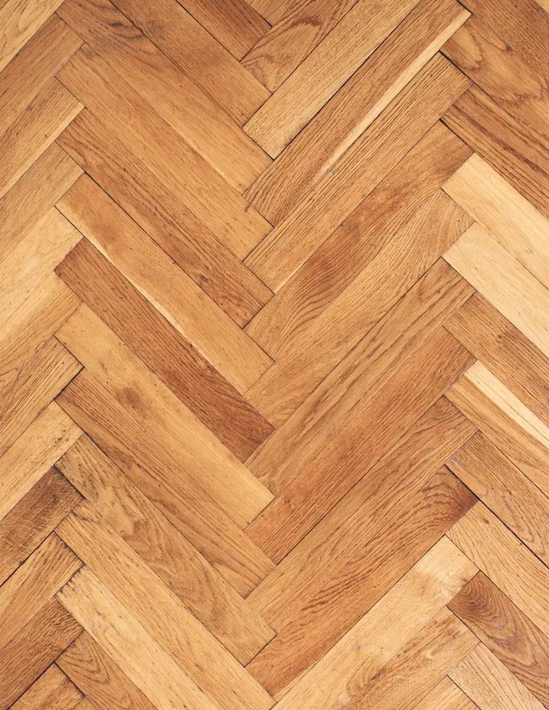 Herringbone wood floor pattern in warm oak tones